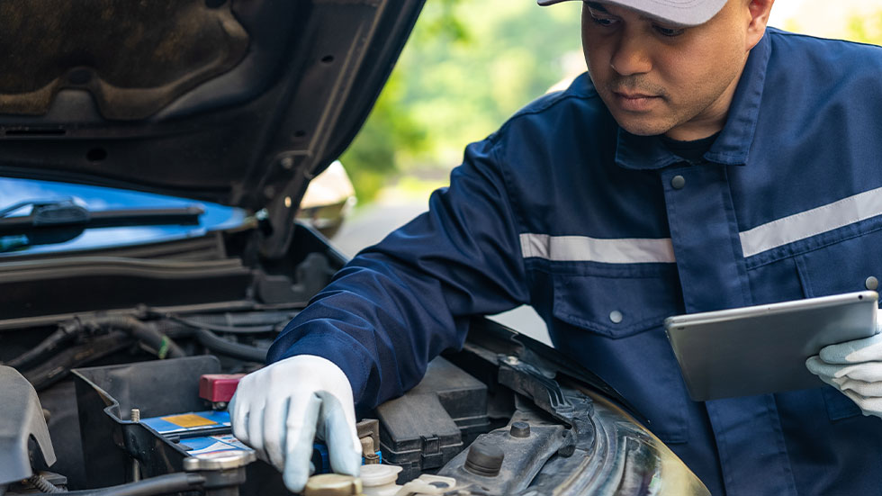 mechanic checking engine fluids